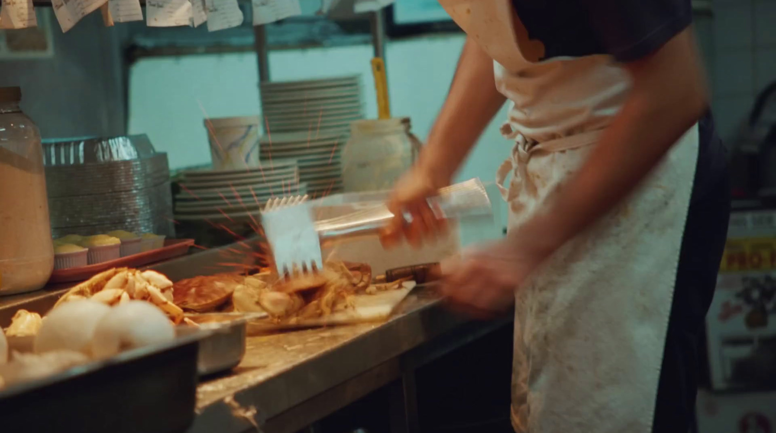 a person standing in a kitchen preparing food