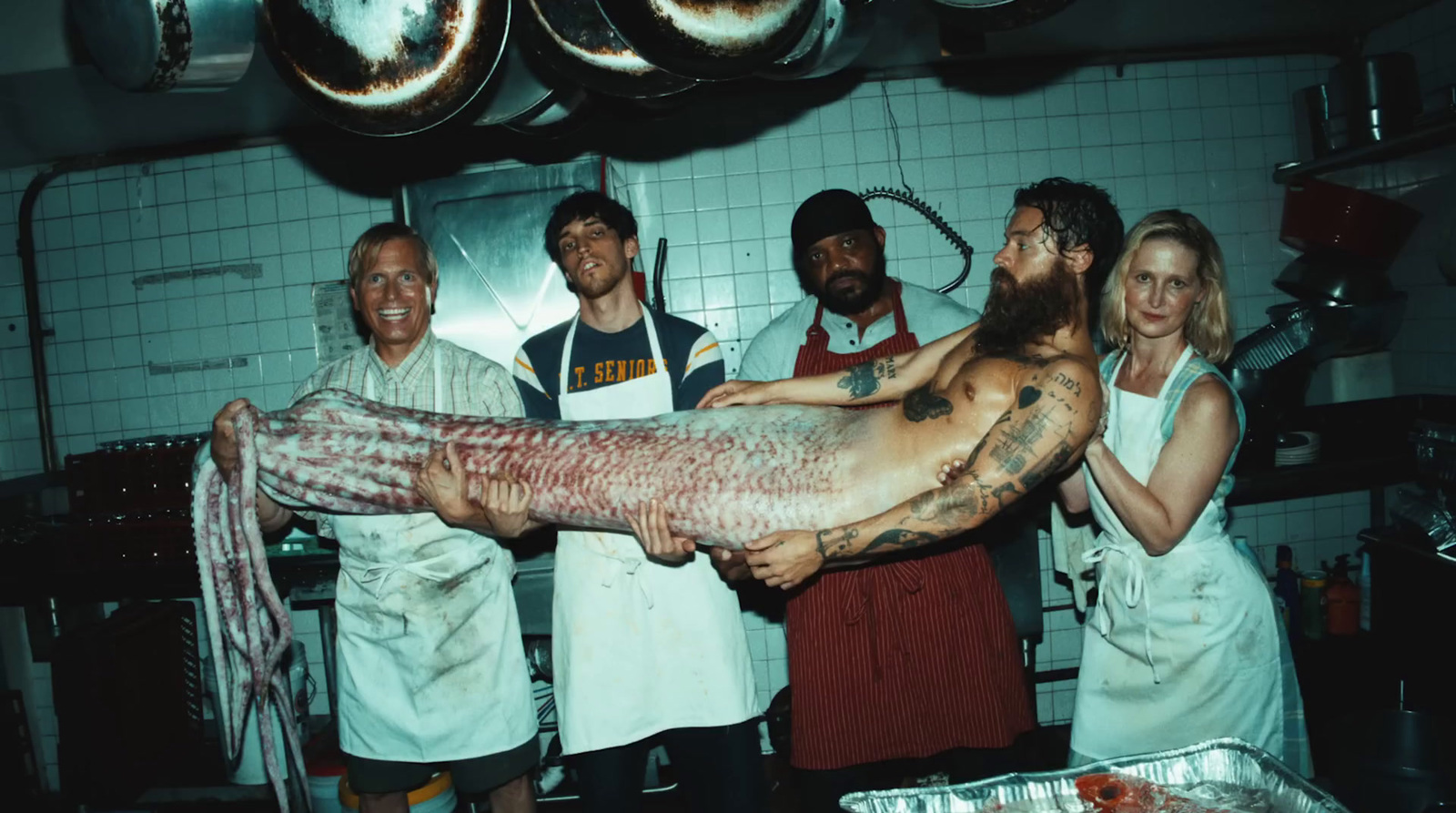 a group of people standing around a large fish