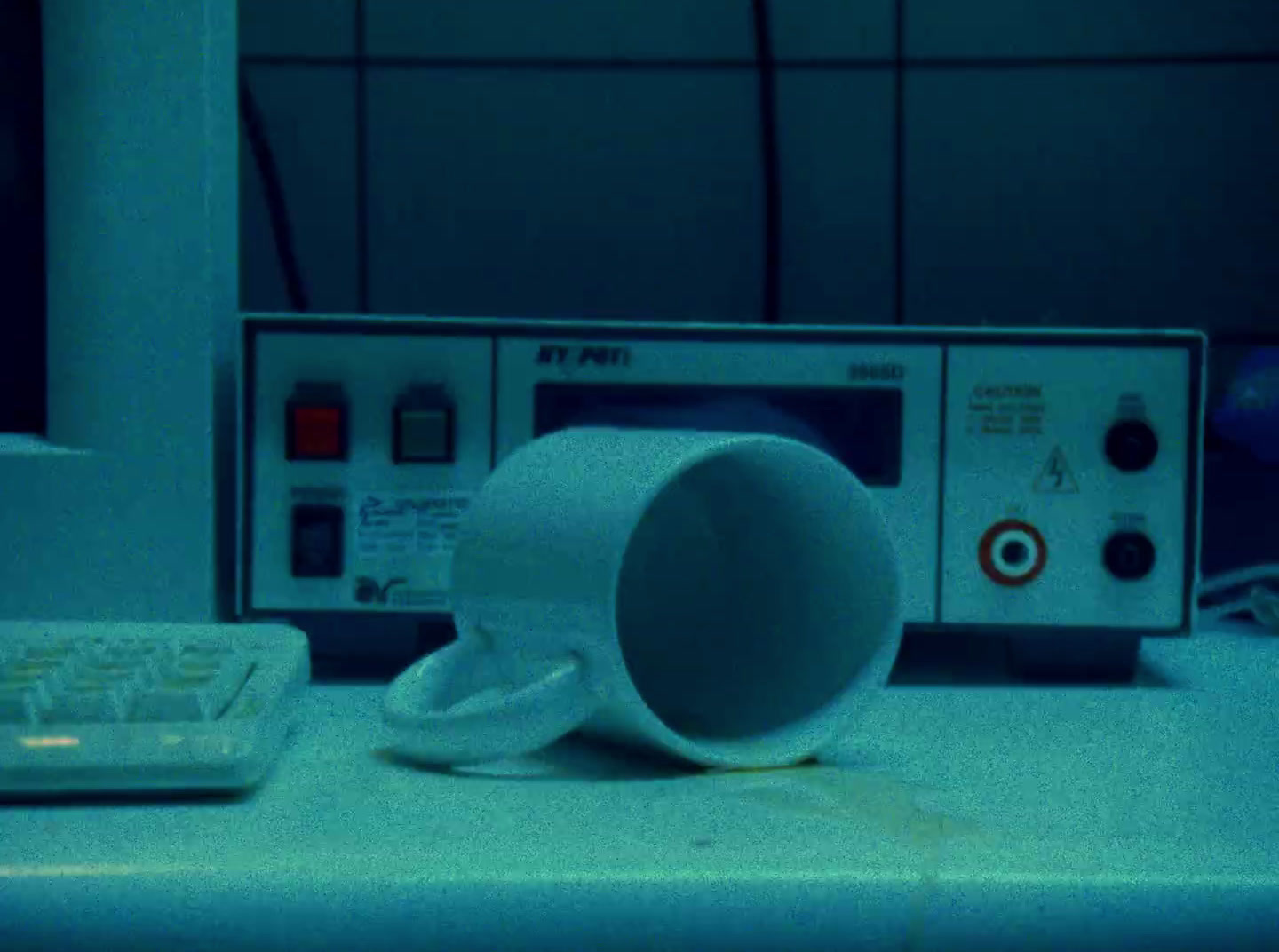 a coffee cup sitting on top of a counter next to a microwave