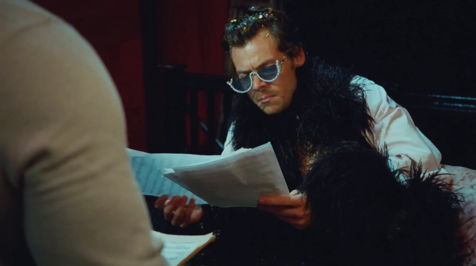 a man in sunglasses reading a piece of paper