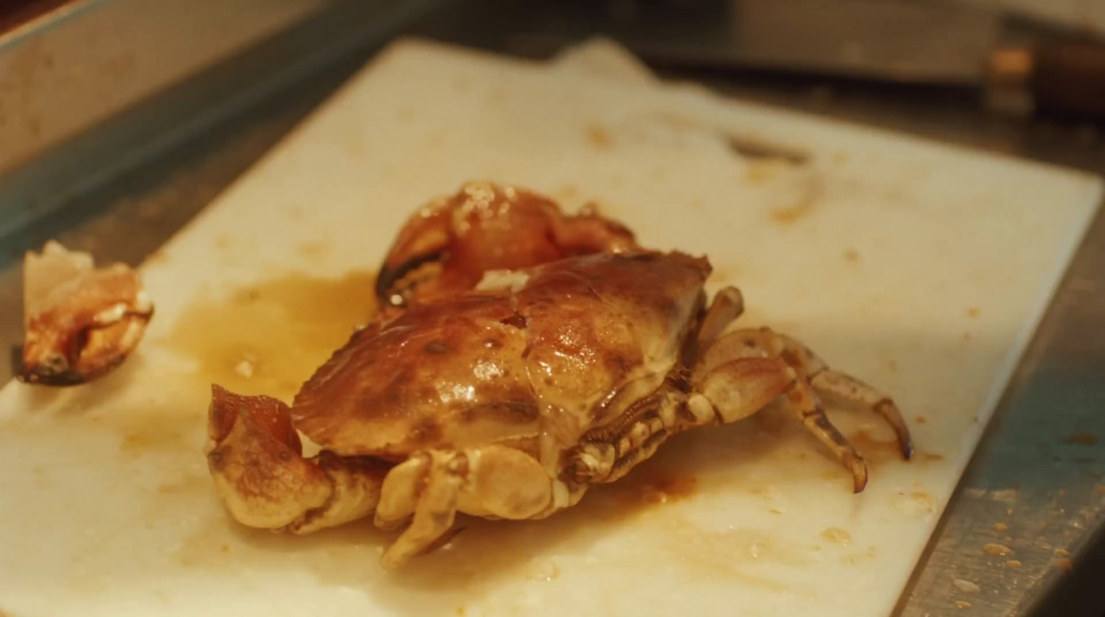 a close up of a crab on a cutting board