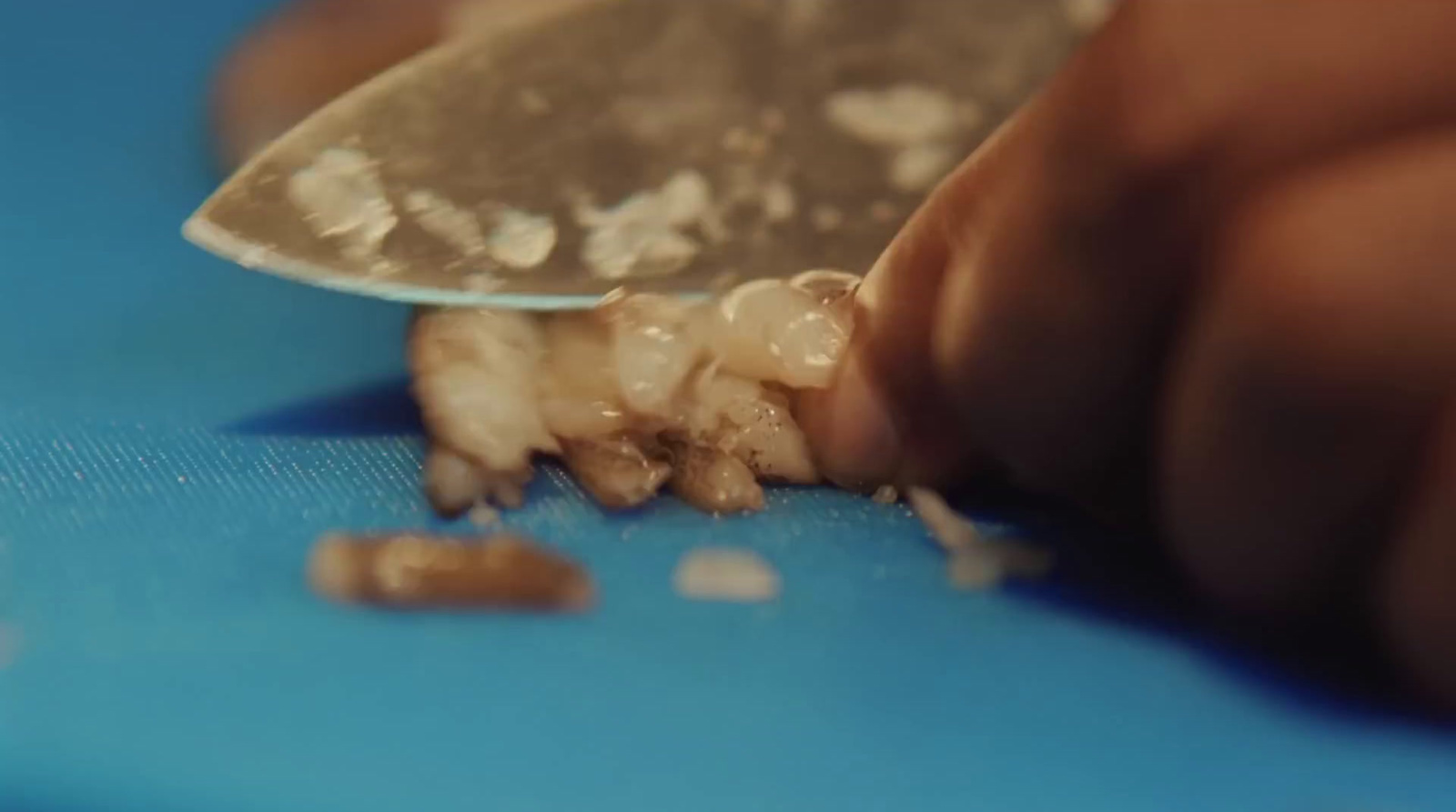 a close up of a person cutting something with a knife