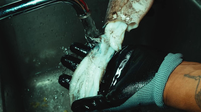 a person washing their hands in a sink