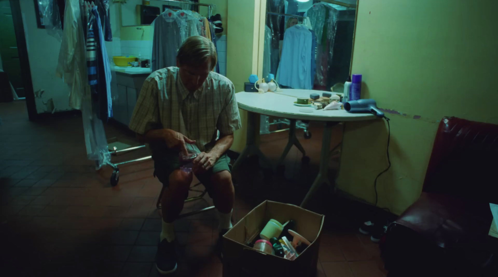 a man sitting on a stool in a room