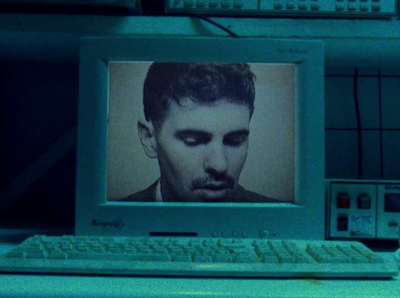 a computer with a picture of a man on the screen