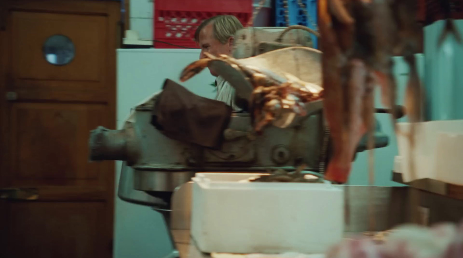 a man working on a machine in a kitchen