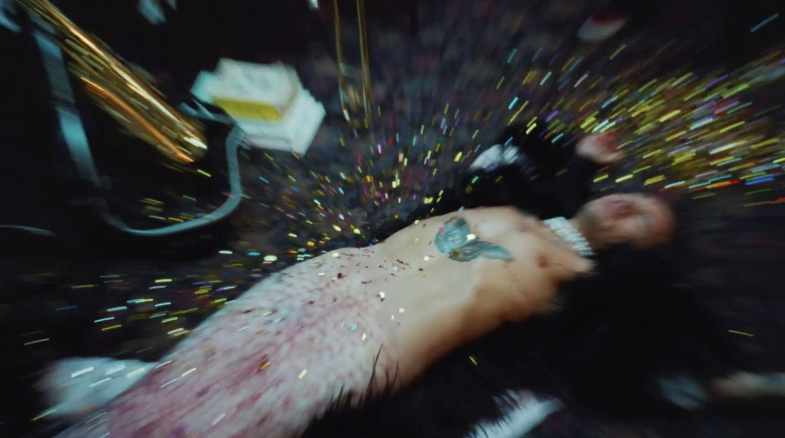 a man laying on top of a table covered in confetti