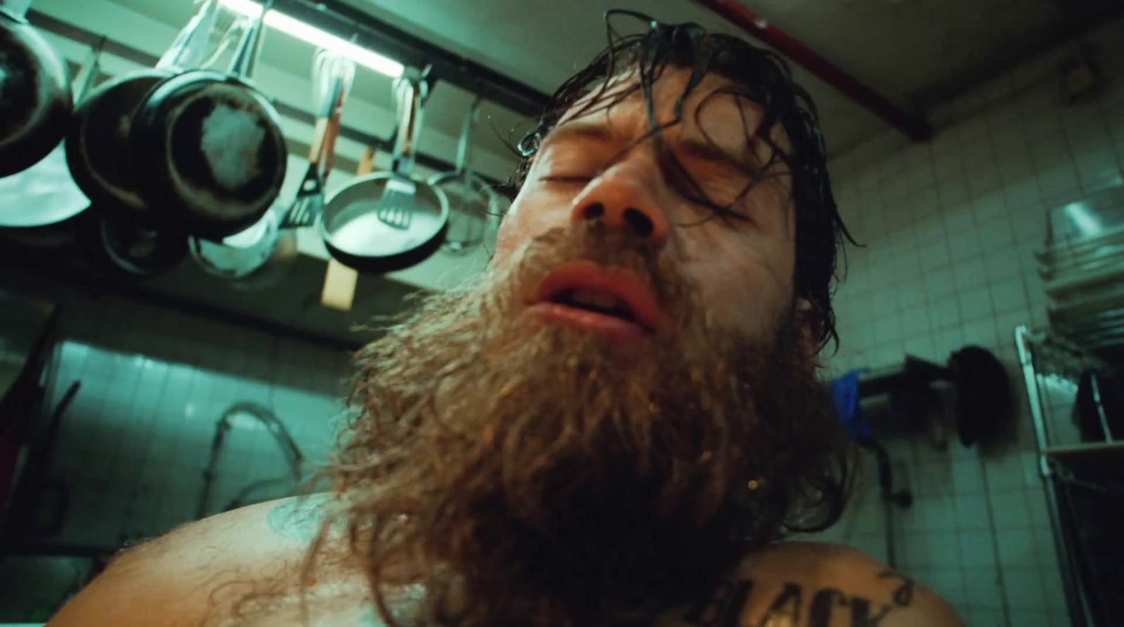 a man with a long beard in a kitchen