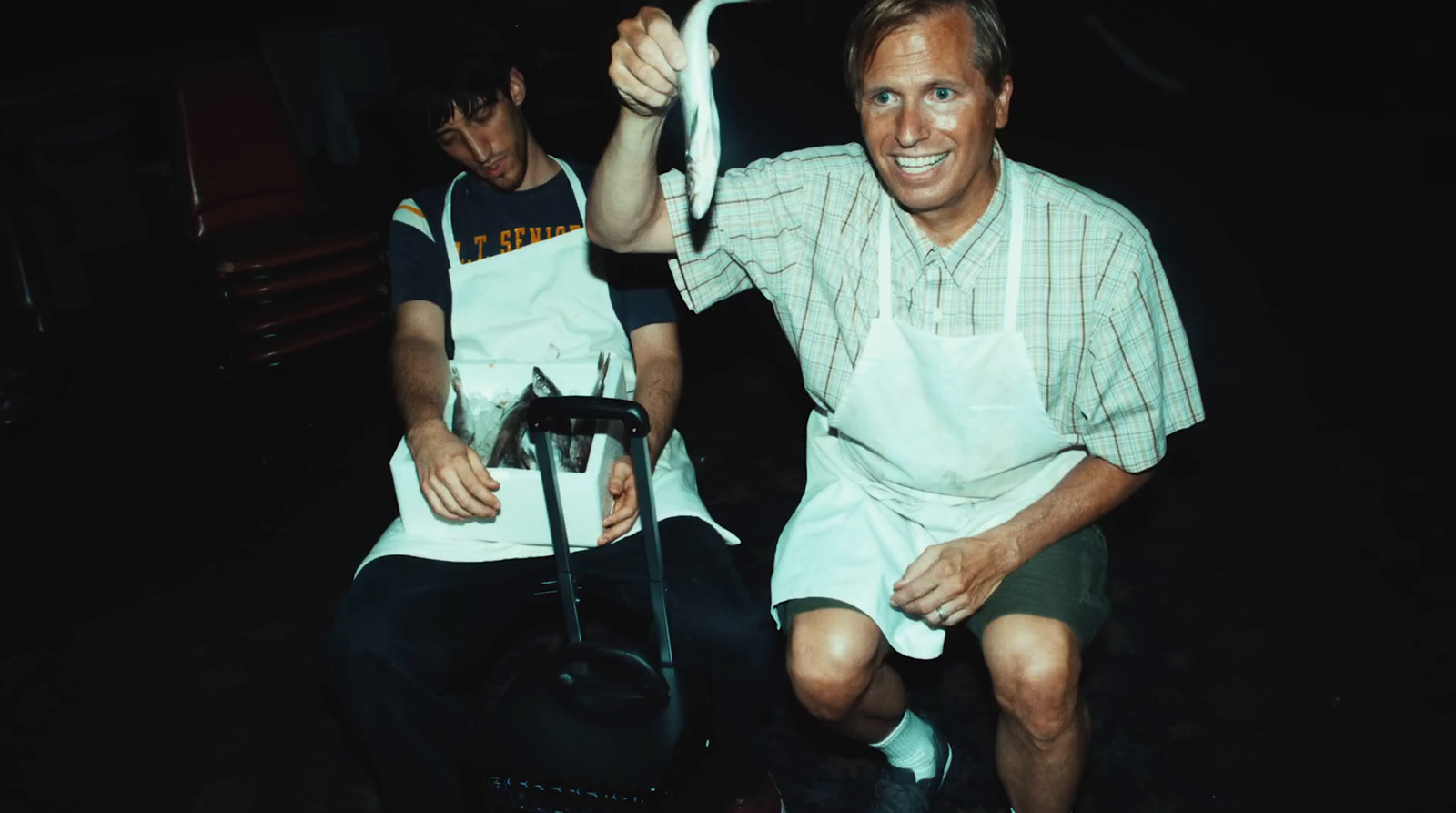 a man sitting on a chair holding a white object