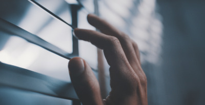 a person's hand reaching out of a window