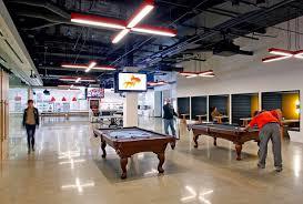 a group of people playing pool inside of a building