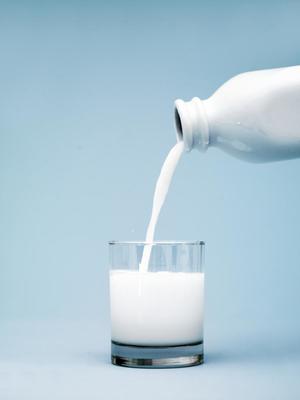 a glass of milk being poured into it