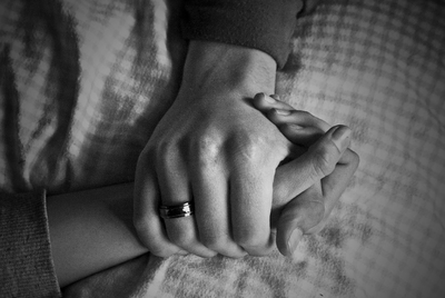 a close up of two people holding hands