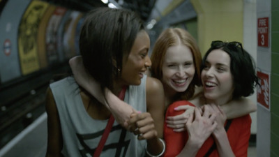 a group of women hugging each other in a subway station