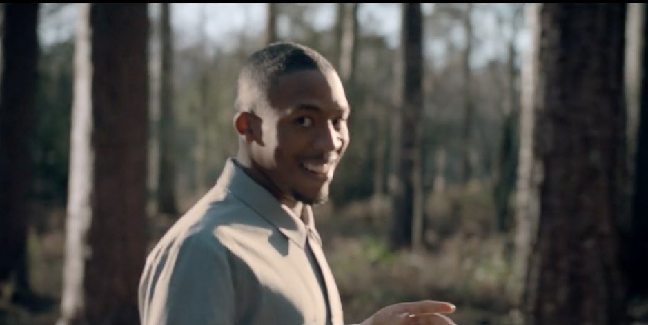 a man standing in the middle of a forest