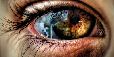 a close up of a person's eye with the reflection of a building in