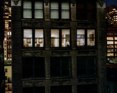 a tall building with lots of windows at night