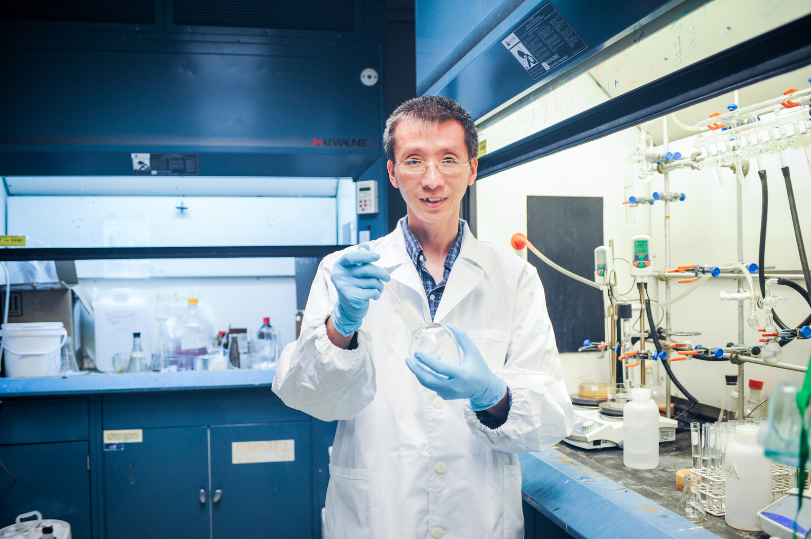 a man in a lab coat holding a pipe