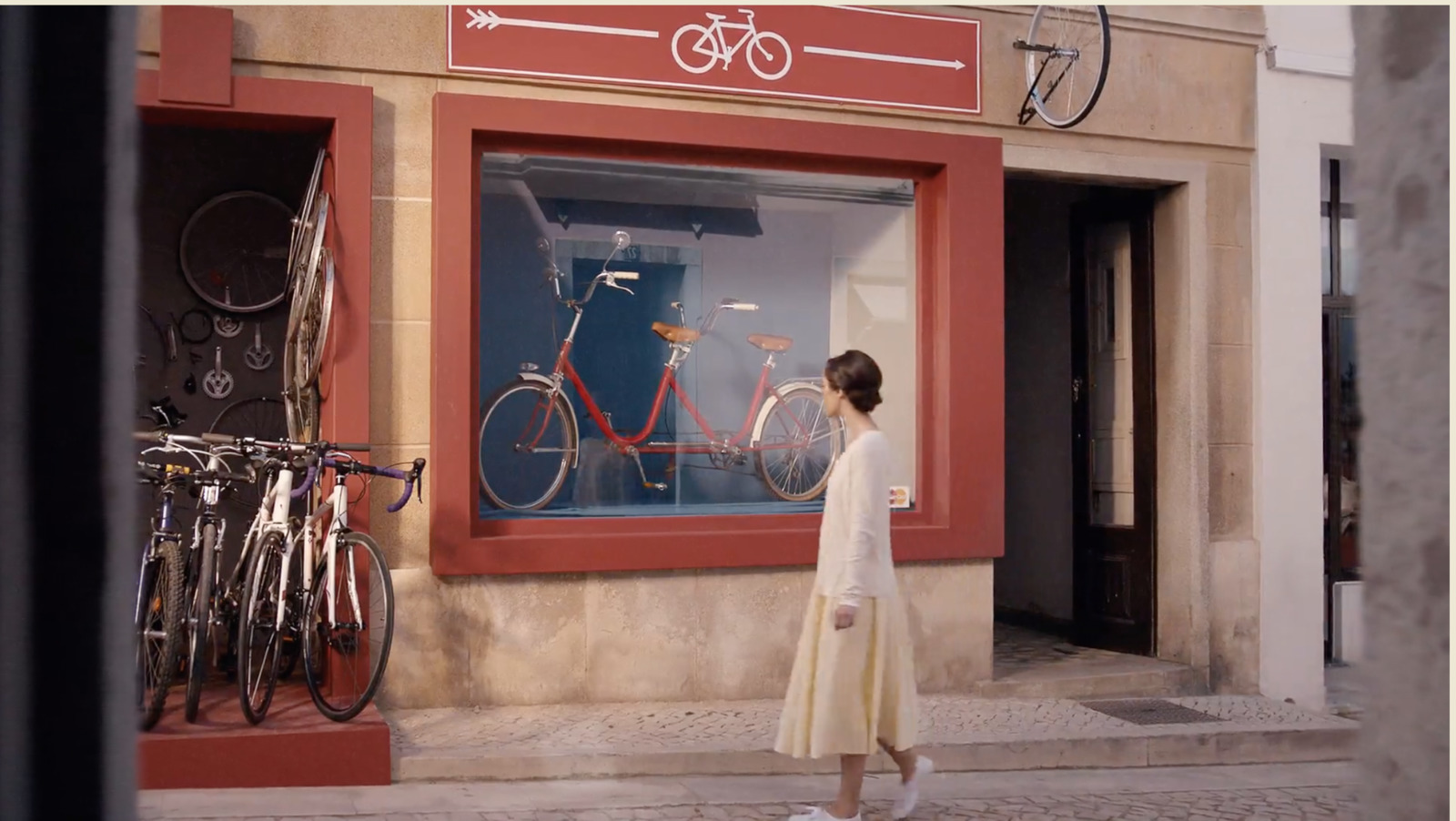 a woman standing in front of a store window