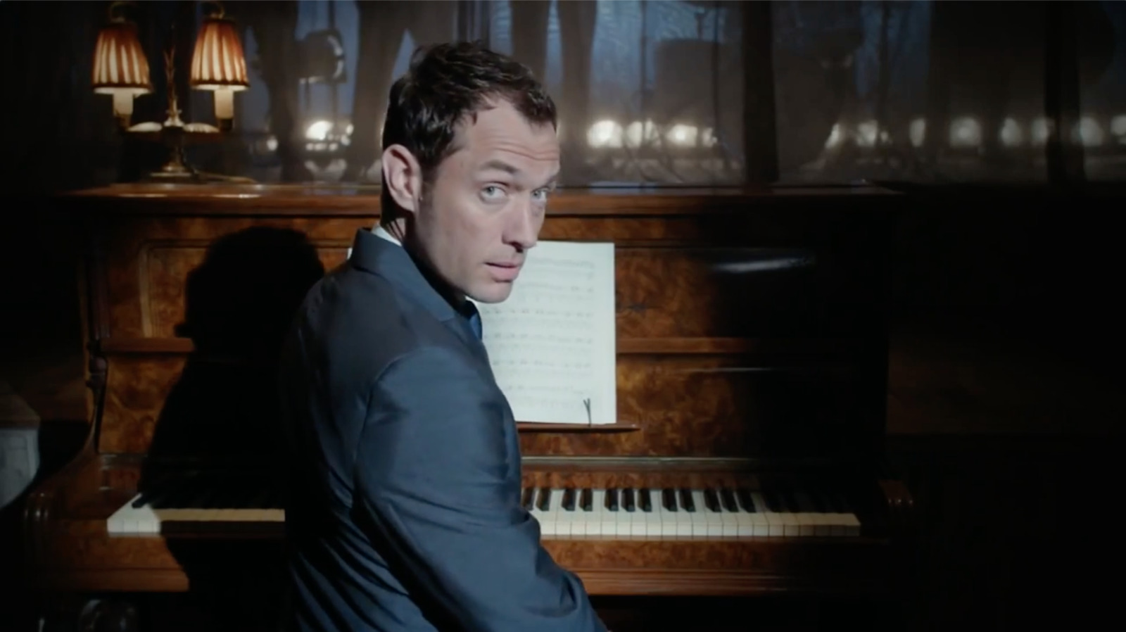 a man sitting in front of a piano