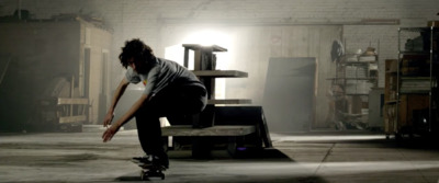 a man riding a skateboard on top of a wooden bench