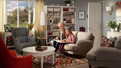 two women sitting on a couch in a living room