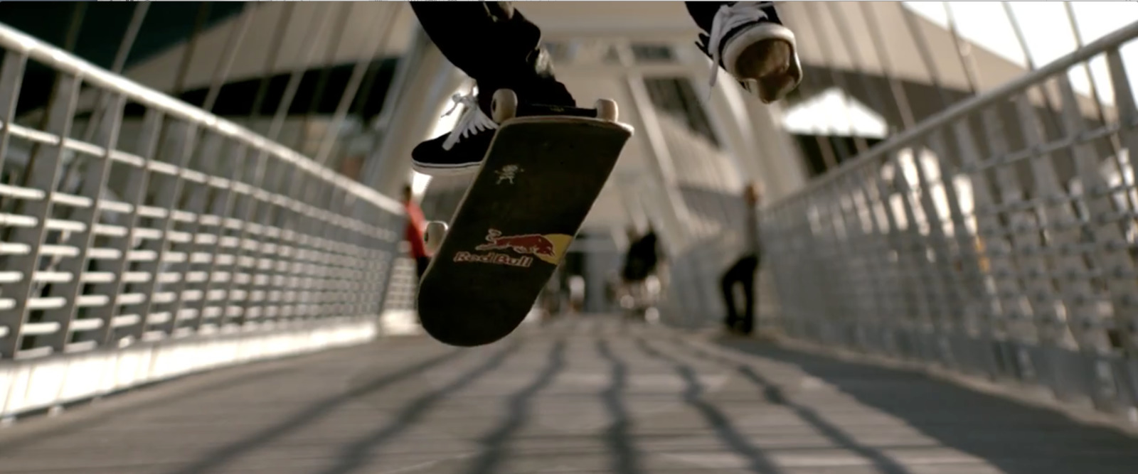 a skateboarder is doing a trick on a bridge