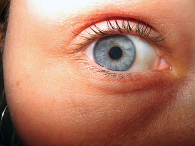 a close up of a person's blue eye