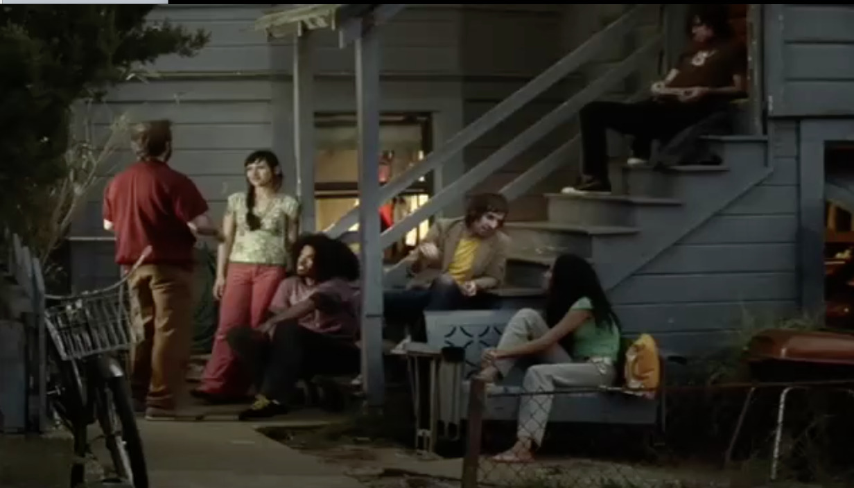 a group of people sitting outside of a house