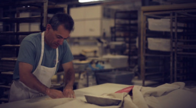 a man in an apron is making a pie