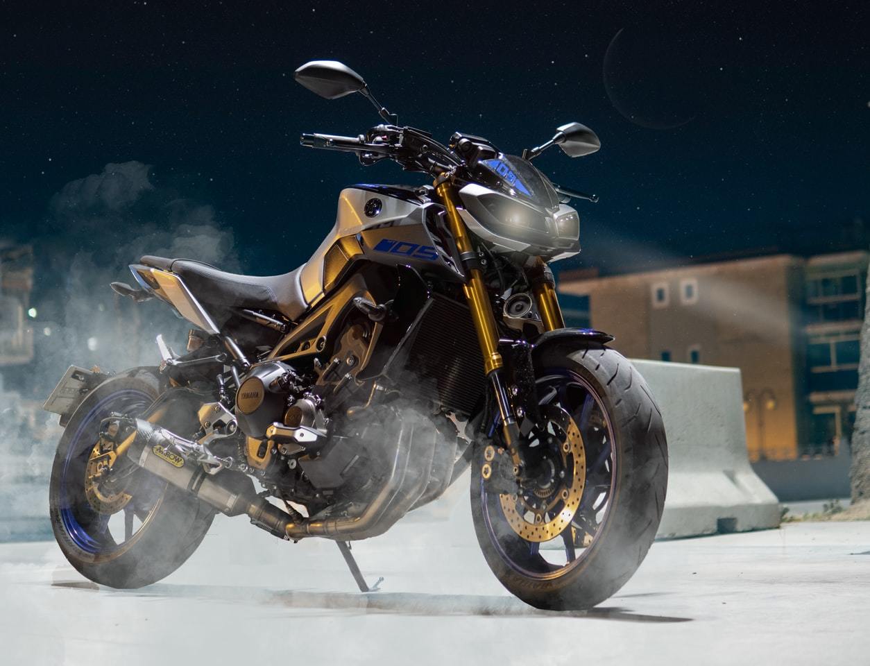 a black and yellow motorcycle with smoke coming out of it