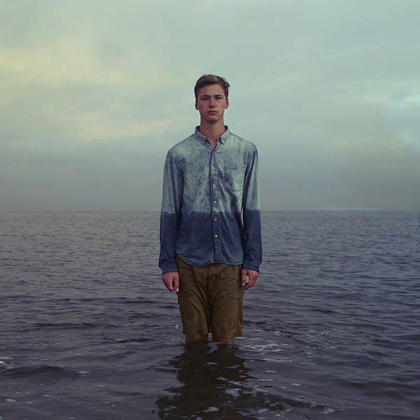 a man standing in the middle of a body of water