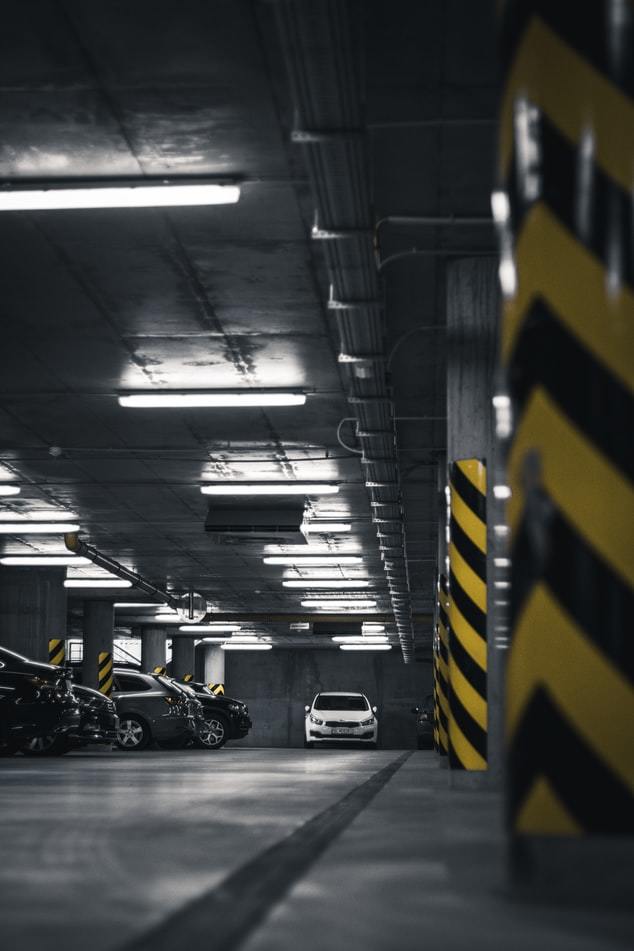 a parking garage filled with lots of parked cars