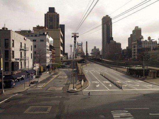 an empty city street with power lines above it