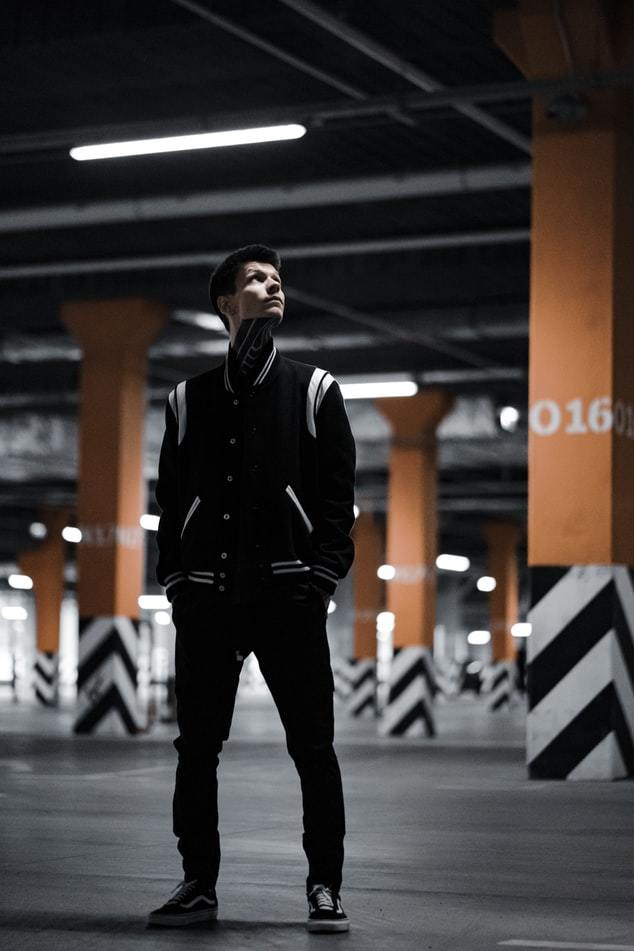 a man standing in an empty parking garage