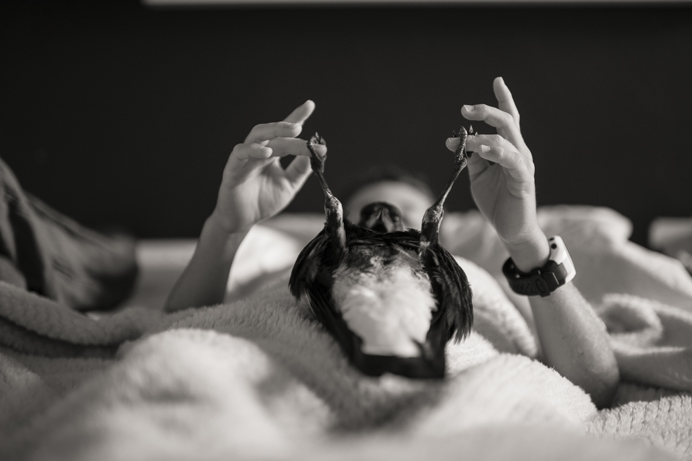 a black and white photo of a woman laying in bed