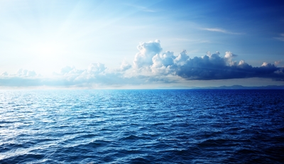 a large body of water under a cloudy sky