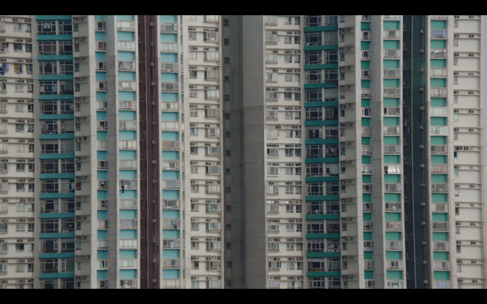 an airplane flying in front of a very tall building