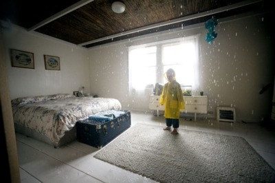 a person standing in a room with a bed