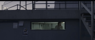 a man looking out of a window in a building