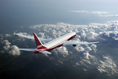 a large jetliner flying through a cloudy sky