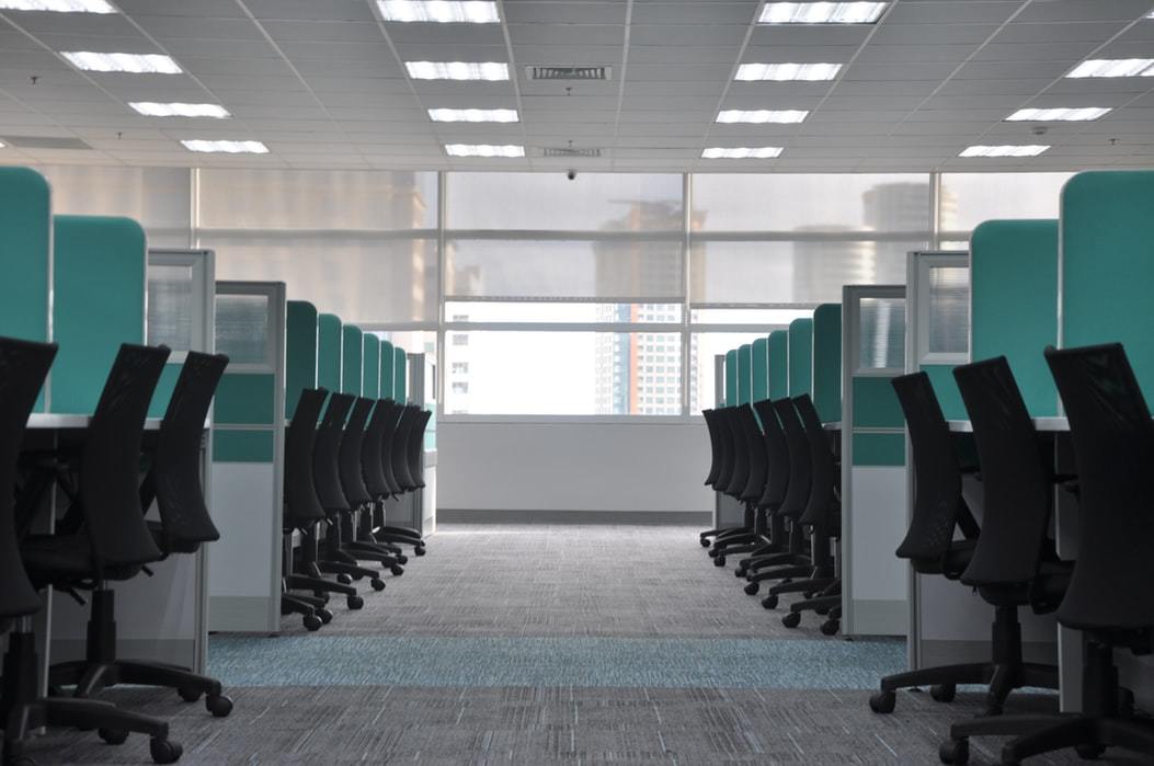 an empty office with a lot of cubicles