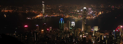 a view of a city at night from the top of a hill