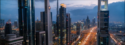 a view of a city at night from the top of a skyscraper