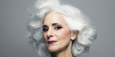 a close up of a person with white hair