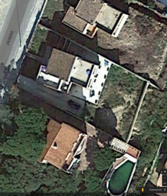 an aerial view of a house in the woods