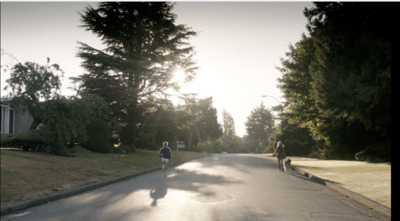 a couple of people walking down a street