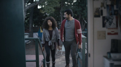 a man and a woman walking down a porch