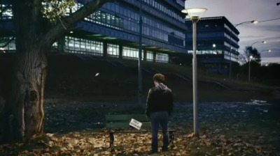 a man standing next to a tree in front of a building