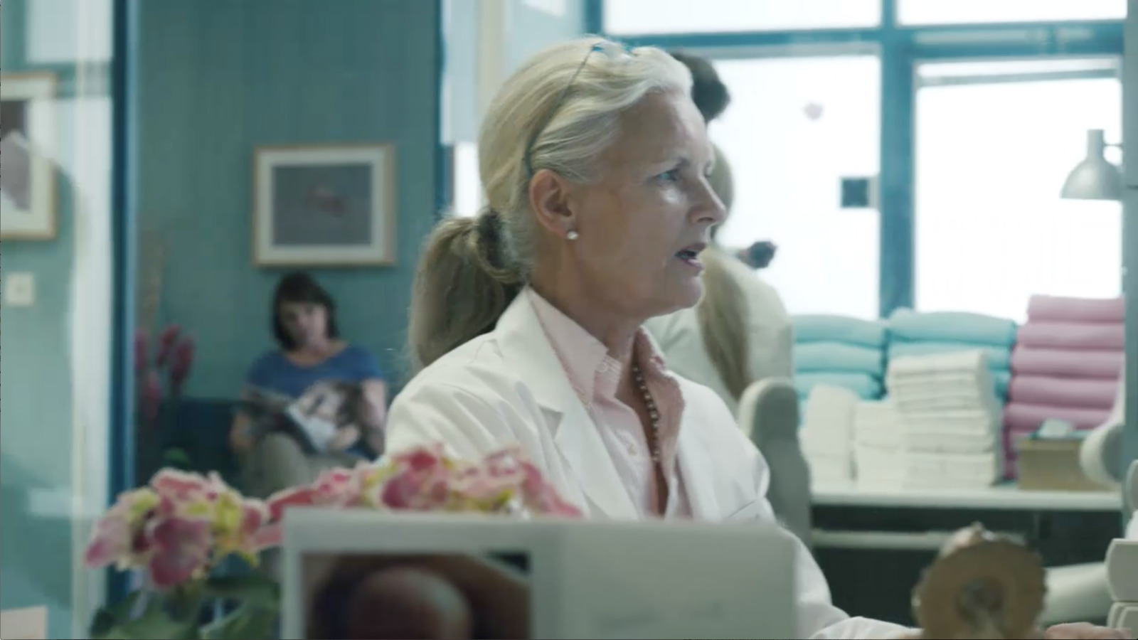 a woman sitting at a desk in a room